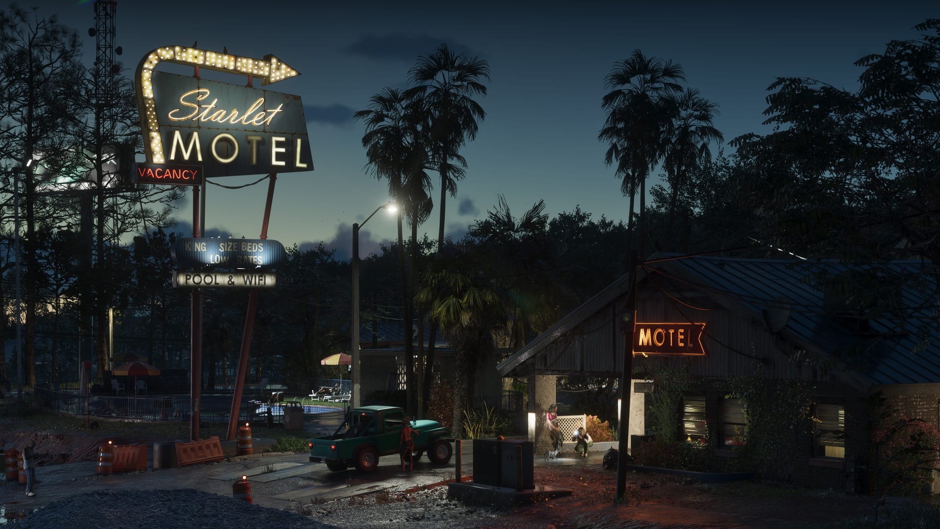 A roadside motel at night under a tall sign reading Starlet Motel, a pickup parked in its forecourt, in an official Grand Theft Auto VI screenshot
